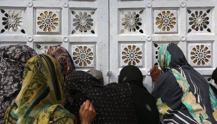 Women devotees gather outside a closed entrance of a hall to get in to search for their belongings, at the tomb of Sufi saint Syed Usman Marwandi, also known as Lal Shahbaz Qalandar, Sehwan Sharif. February 17, 2017. REUTERS/Akhtar Soomro