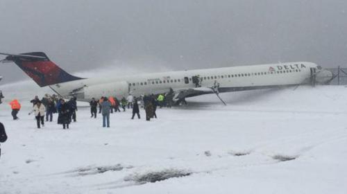 Airliner skids off La Guardia runway amid winter storm