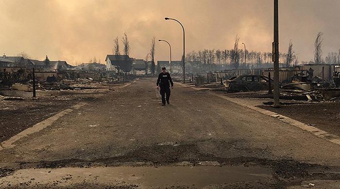 Canadian wildfire explodes in size, forces more evacuations