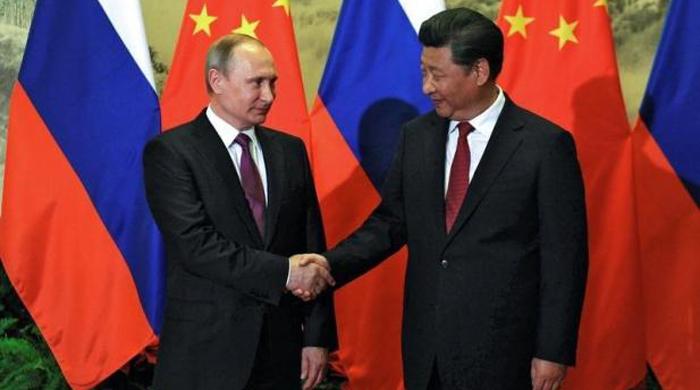 Russia secures energy deals, talks security with China as Putin visits
