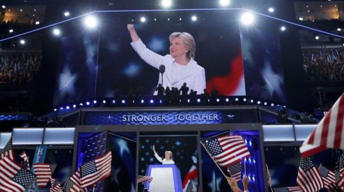 Accepting the nomination, Clinton casts herself as clear-eyed leader