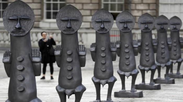 Army of black statues stands guard at African art show in London