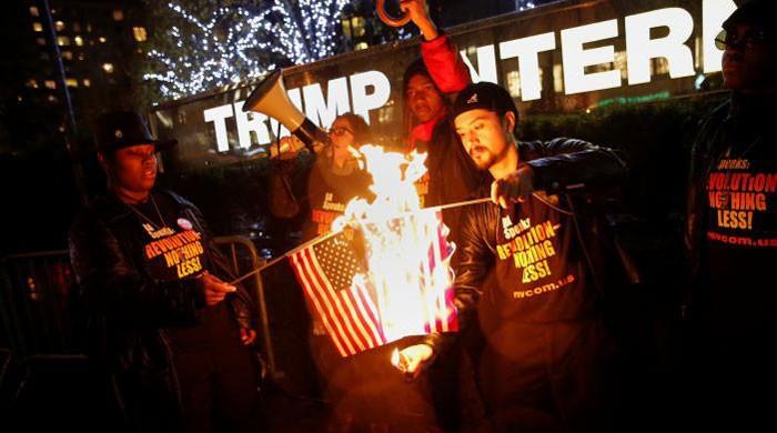 Activists burn flags in New York after Trump's flag-burning tweet