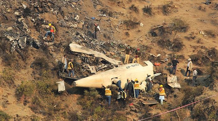 Investigation team collects samples from PIA crash site