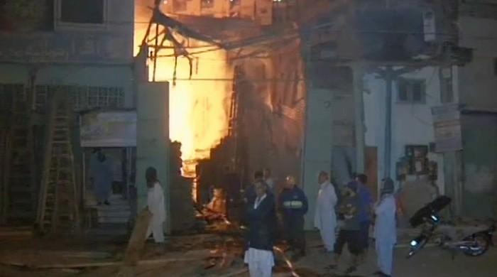Rescue workers douse fire at wood warehouse in Karachi