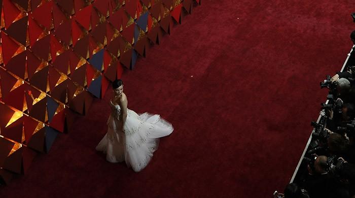 Stars shimmer on Oscar red carpet as diamonds and gold have their day