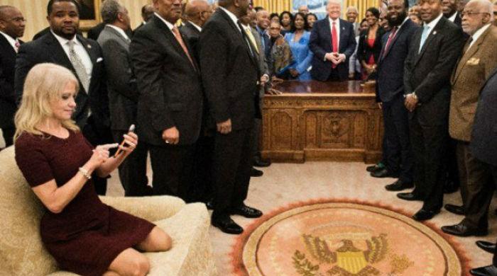 Trump aide Conway draws ire for kneeling on White House sofa