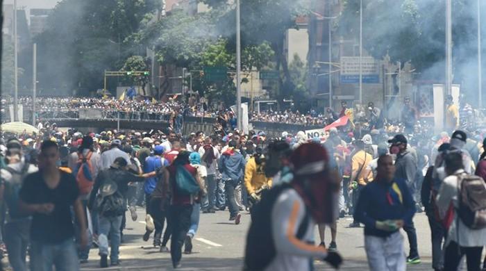 Venezuelan protesters clash with police at rally, roused by ban on opposition leader