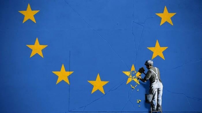 Banksy chips away at EU flag in first Brexit mural