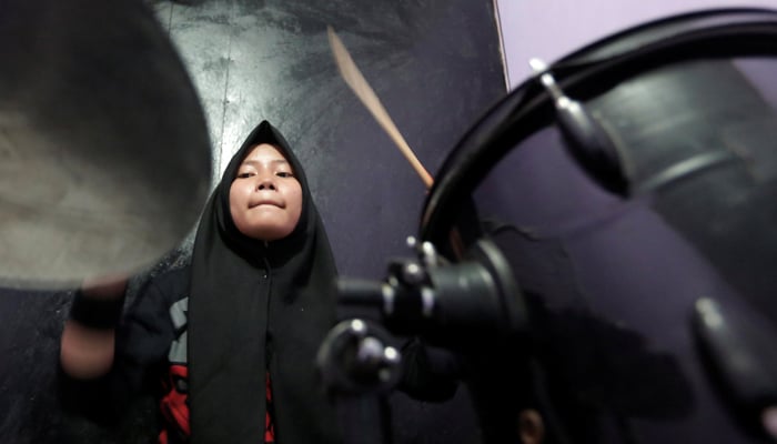 Euis Siti Aisyah, a member of the heavy metal band Voice of Baceprot, practices at a studio before she performs in Garut, Indonesia, May 14, 2017. REUTERS/Yuddy Cahya