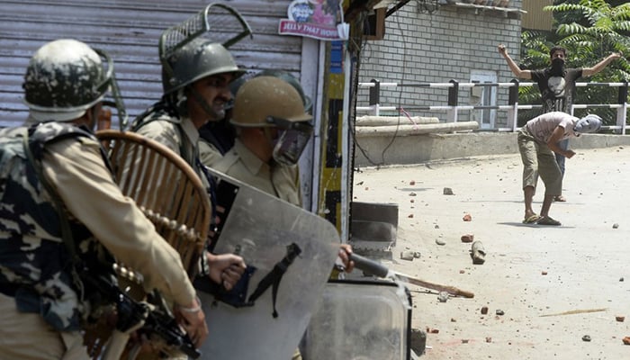 Kashmiri protesters throw stones towards Indian forces during clashes in Srinagar