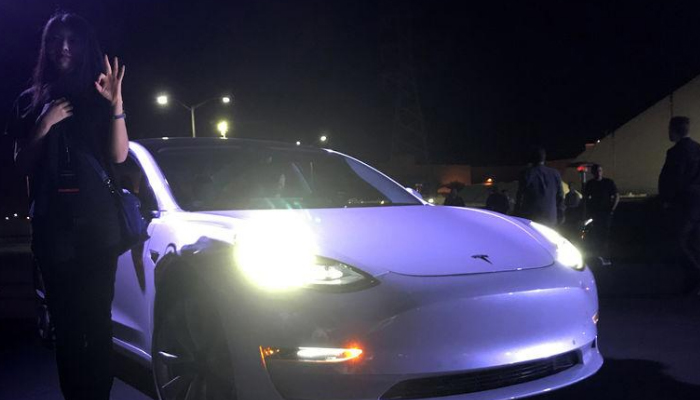 Tesla's Musk hands over first Model 3 electric cars to early buyers
