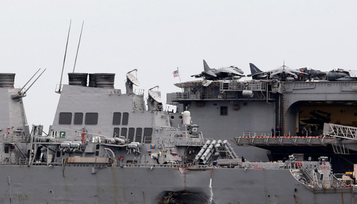 US divers find body remains in hull of damaged destroyer