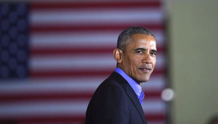 Obama slams 'politics of division' on return to campaign trail