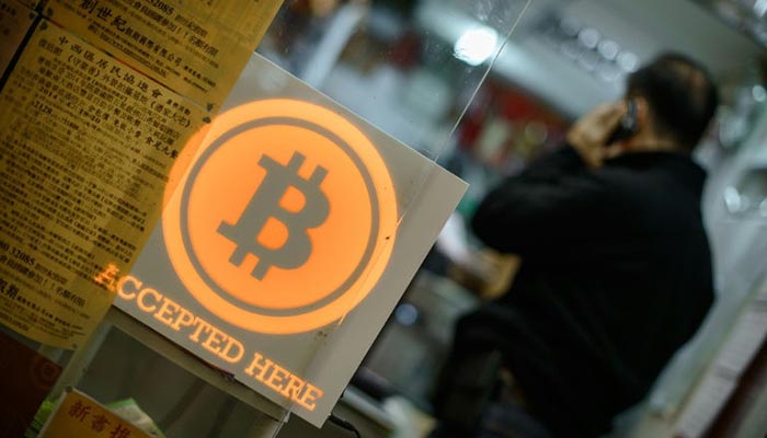 Bitcoin tops $18,000 in debut on major bourse