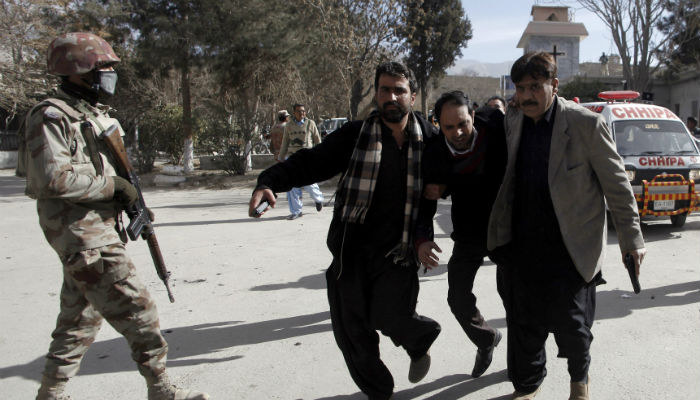 Plain-clothed security officers help an injured man after gunmen attacked the Bethel Memorial Methodist Church in Quetta, Pakistan December 17, 2017. Photo: REUTERS
