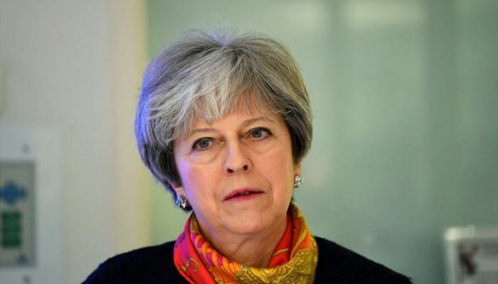 British PM May apologizes as overwhelmed hospitals cancel non-emergency operations