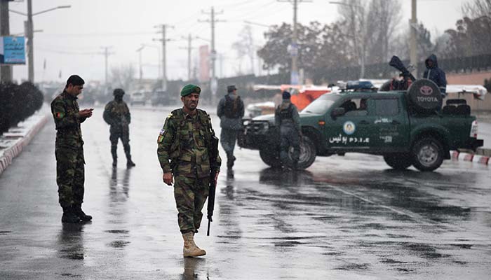 Afghan security personnel stand guard near the site of an attack near the Marshal Fahim military academy base in Kabul on January 29, 2018 - AFP