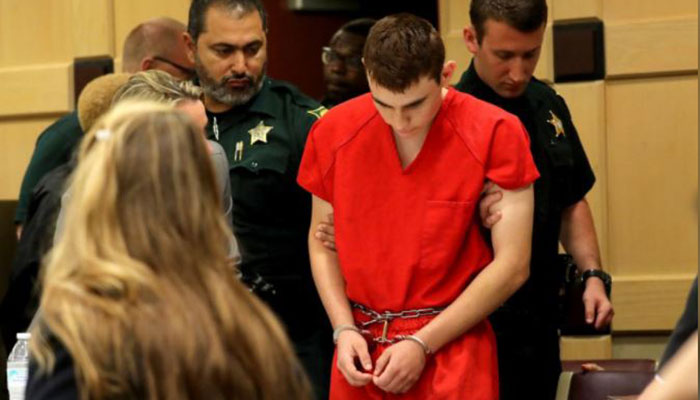 Head bowed, Florida shooting suspect returns to court for hearing