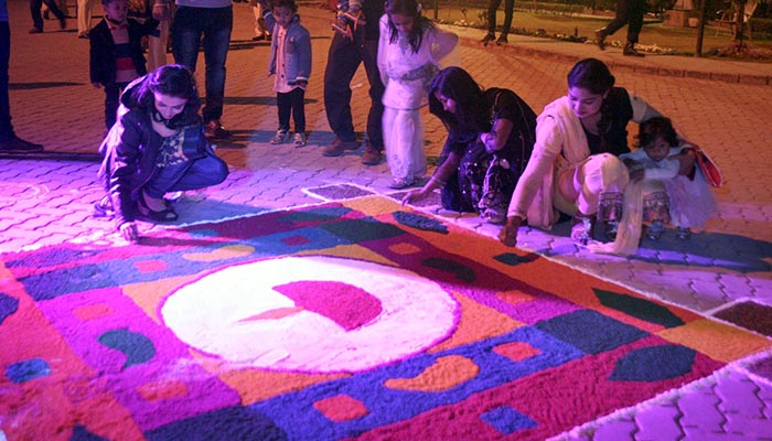 Women of the Hindu community are making ‘rangoli’ on the floor using colors at Pakistan National Council of the Arts (PNCA) in connection with celebrations of Hindu festival Holi - Online