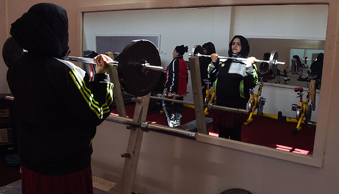Female powerlifters flex their muscles in Afghanistan
