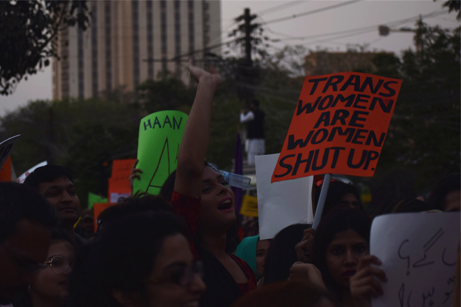 A girl carries a placard that reads 'Trans women are women; shut up' during the Aurat March 2018 held at Frere Hall, Karachi, Pakistan, March 8, 2018. Geo.tv/Author