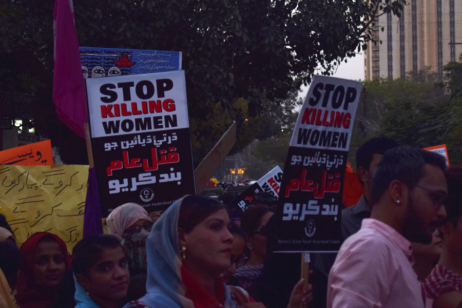Girls carry placards that read 'Stop killing women' during the Aurat March 2018 held at Frere Hall, Karachi, Pakistan, March 8, 2018. Geo.tv/Author