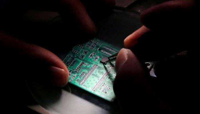 China looks to speed up chip plans as US trade tensions boil - sources