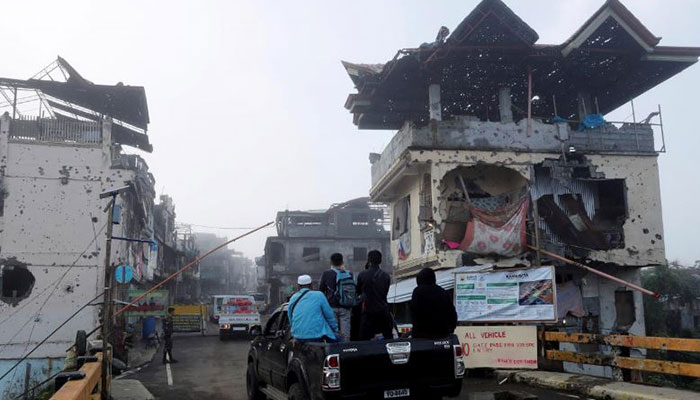 Teary-eyed, hundreds search through rubble in devastated Philippines city