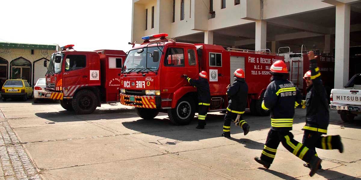 Rescue workers save people from a building fire in Pakistan