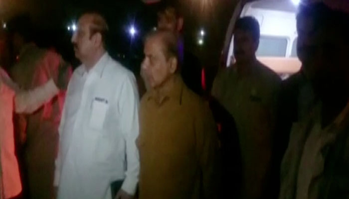 Punjab Chief Minister Shehbaz Sharif awaiting Ahsan Iqbal after a helicopter shifted him from Narowal to Lahore on Sunday, May 6, 2018. Photo: Geo News