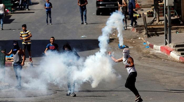 Israeli forces martyr two Palestinians in Gaza border protests  A Palestinian protester uses a sling to hurl back a tear gas canister fired by Israeli. Photo: ReutersGAZA: Israeli forces martyred two Palestinians, one of them a 14-year-old boy, and wounded 415 others with live fire and tear gas during protests...