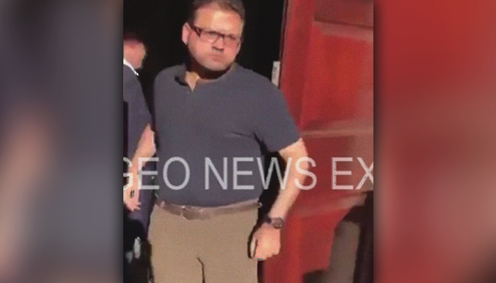 Hussain Nawaz comes out of his apartment as protesters try to break into the Sharifs' Avenfield flats in London, Britain, July 9, 2018. Geo.tv via Geo News/Screenshot