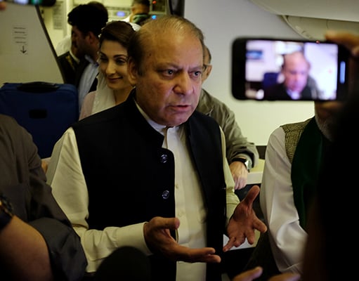 Former prime minister Nawaz Sharif gestures as he boards a Lahore-bound flight due for departure, at Abu Dhabi International Airport, UAE July 13, 2018. Photo: Reuters