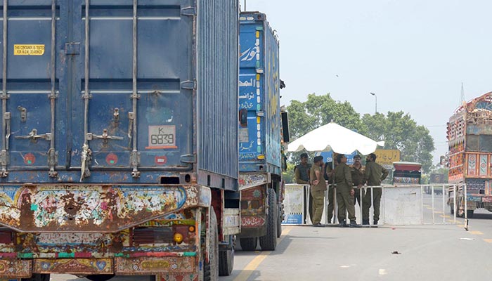 Containers parked at Band road in Lahore. Photo: Online