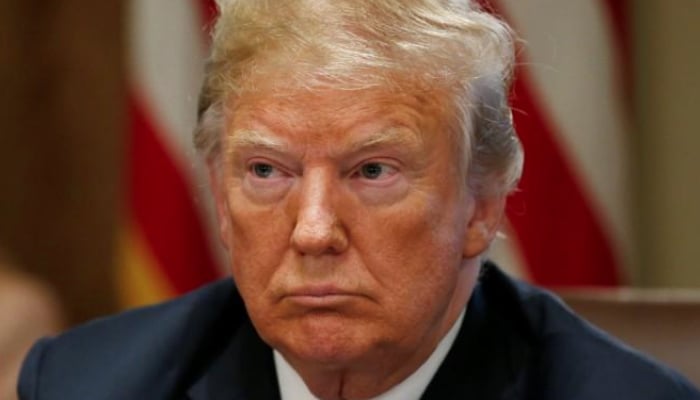 US President Donald Trump listens during a cabinet meeting at the White House in Washington US