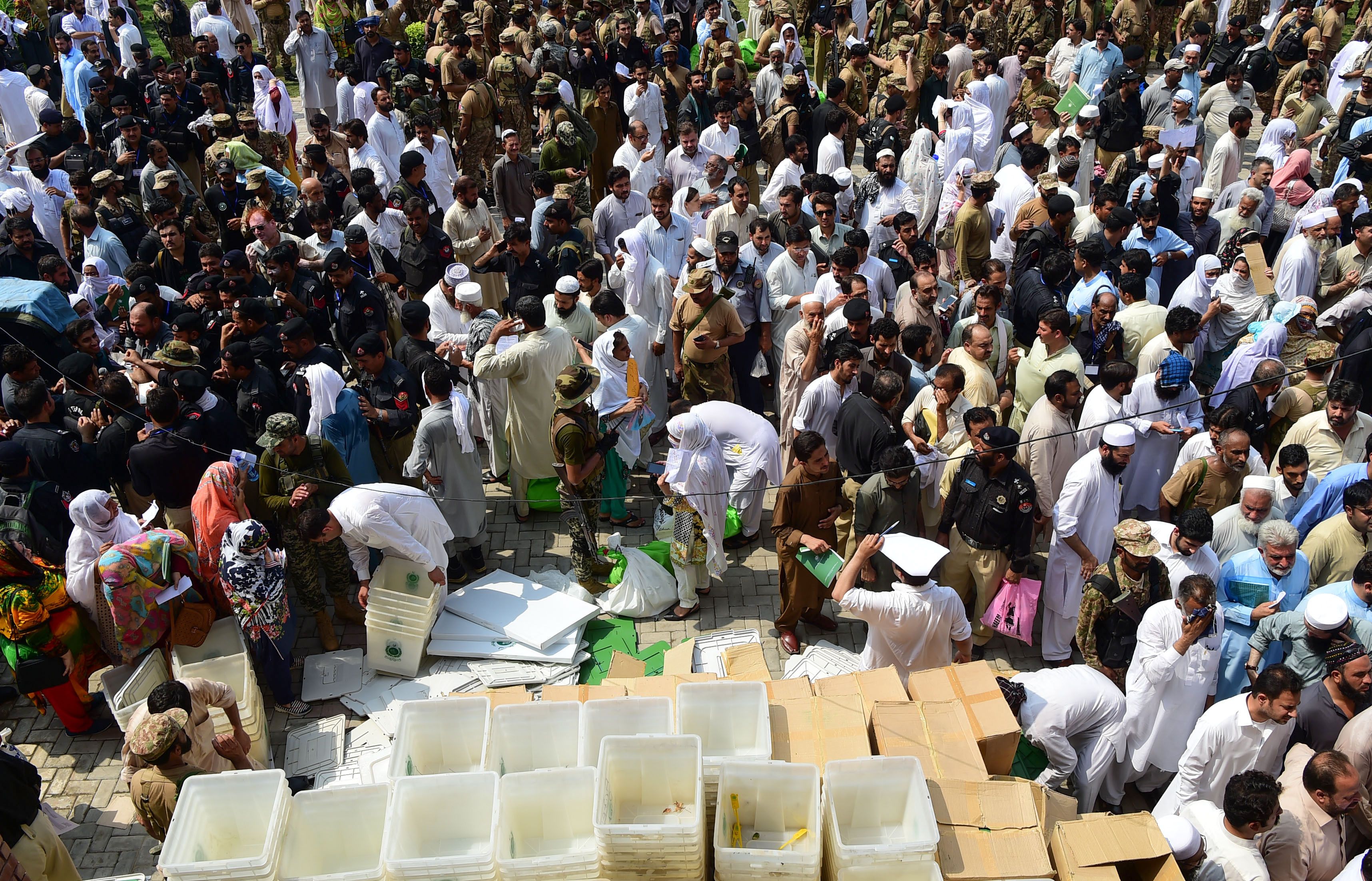 Pakistani election officials receive ballot boxes and voting materials at a distribution centre in Peshawar on July 24, 2018. Photo: AFP