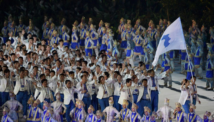 Two Koreas march together as Asian Games burst into life