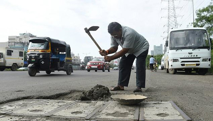 Indian man fills potholes out of love for dead son