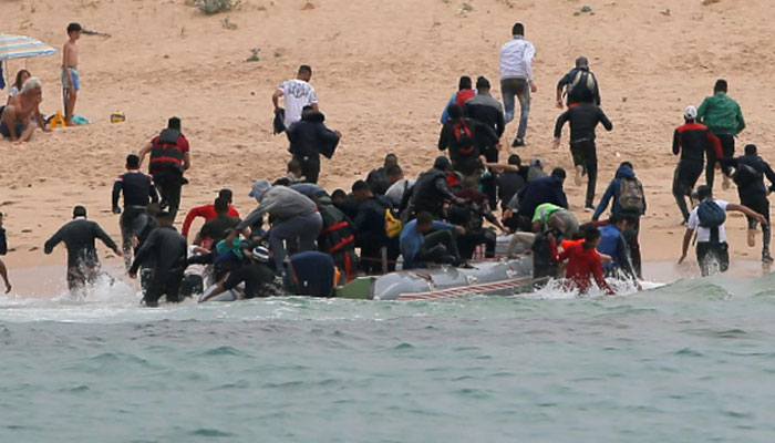 Hundreds of migrants storm Spanish enclave in North Africa, one dies