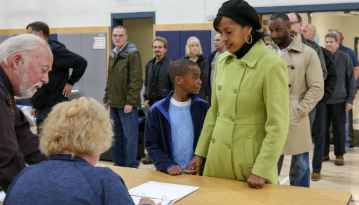 US Democratic Congressional candidate Jahana Hayes with her son Myles checks in to receive her ballot to vote-Reuters