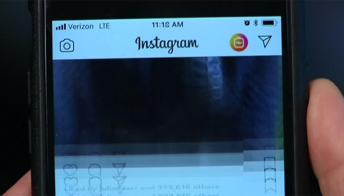 A person uses the Instagram app on their phone