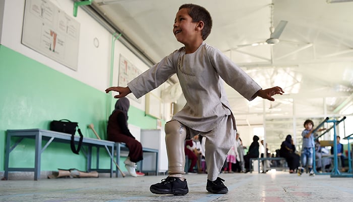 Afghan boy dances to celebrate new prosthetic leg