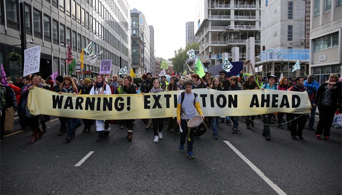 Climate protester lies atop aeroplane to disrupt London City airport