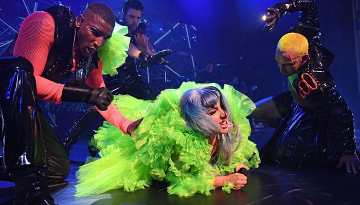 Lady Gaga falls off stage while dancing with eager fan