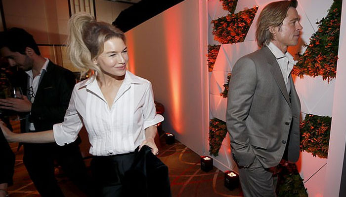 Brad Pitt slips away from Renee Zellweger at the Academy Awards Nominees Luncheon