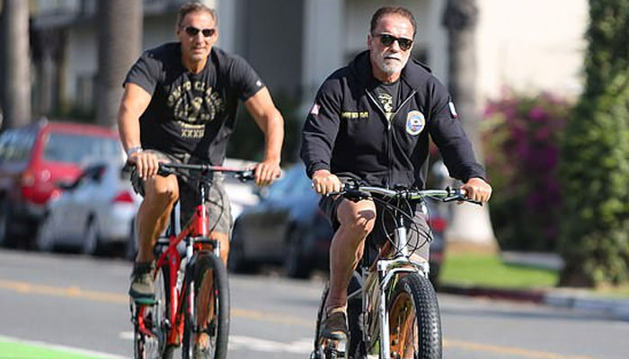 Arnold Schwarzenegger shows off his fitness as he takes bike ride with pal