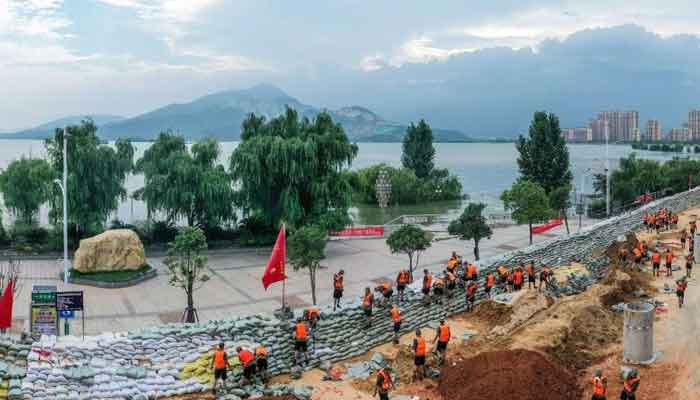 China erects sandbag flood barriers after record rainfall