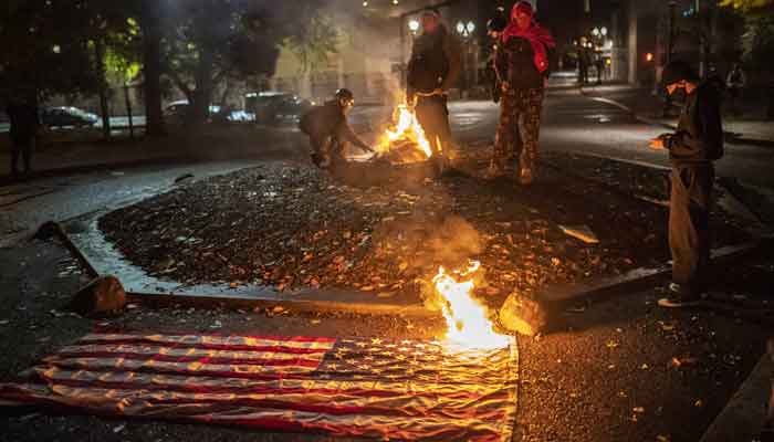 Biden vs Trump: Tensions in Portland rise as protesters burn US flags