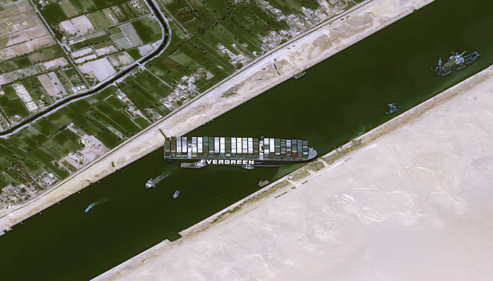 Tugs and dredgers working to free ship blocking Suez Canal